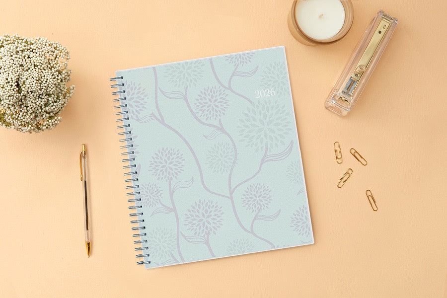 Mint green planner with floral patterns and &