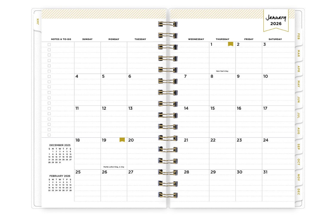 Spiral-bound planner with a monthly calendar layout on a white background lined writing space, white monthly tabs