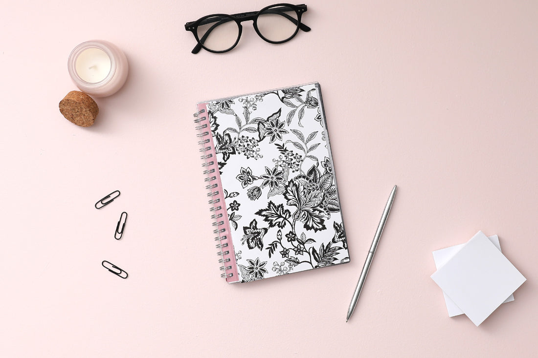 weekly and monthly planner featuring a black and white floral front cover pattern with twin wire-o binding in a 5x8 planner size academic planner