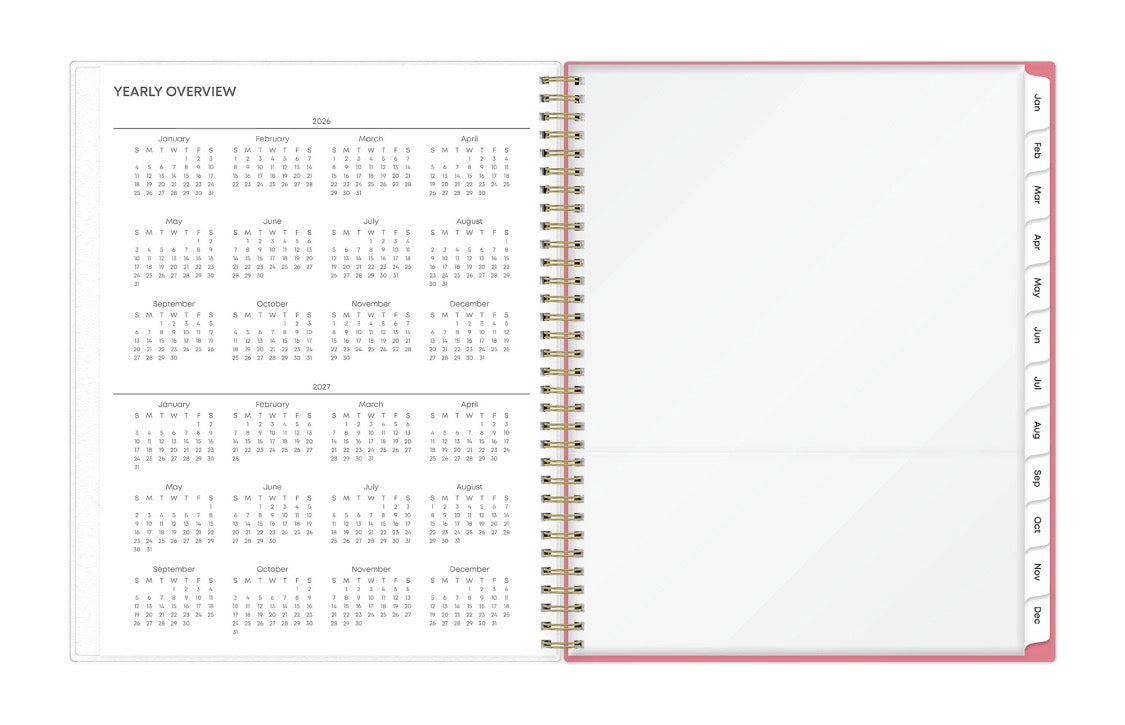 Open planner showing yearly overview with a pink cover and gold binding. 2026 and 2027 years
