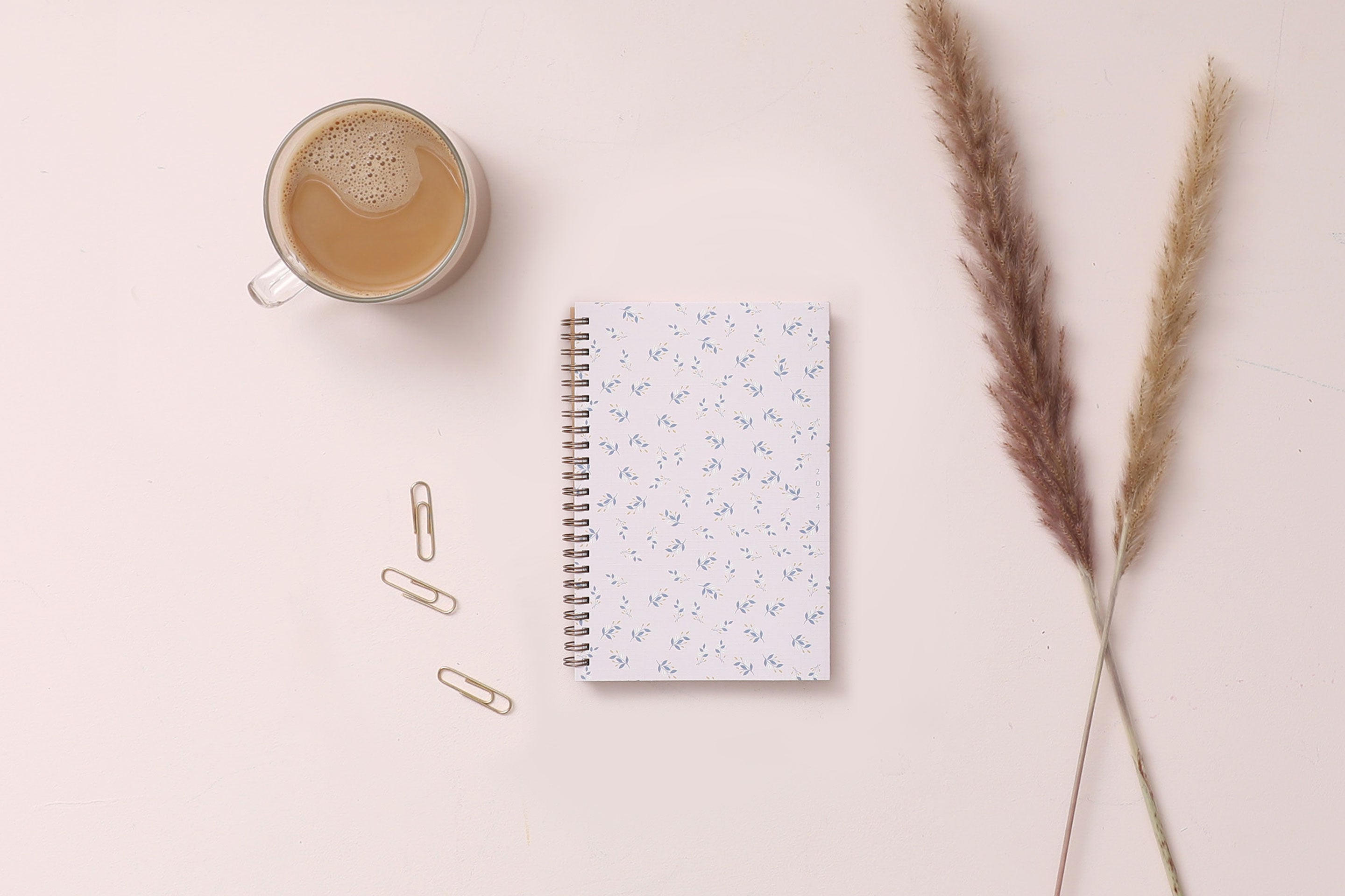 this one tree planted partnership planner for 2024 featuring a floral front cover with pink background and gold twin wire o binding in 5x8 planner size.