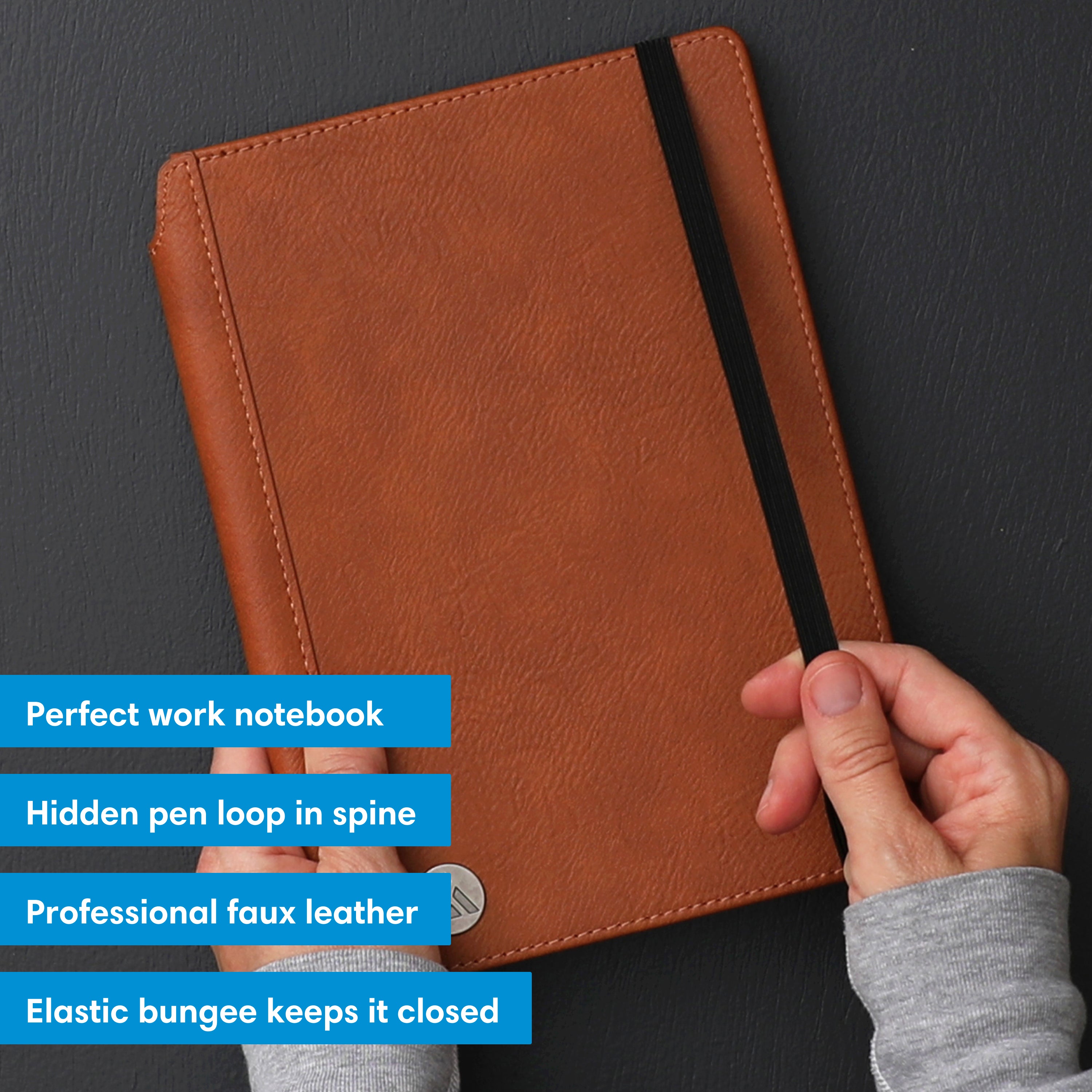 Brown notebook with a black elastic strap on a white background