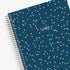 Spiral-bound planner with a blue cover featuring colorful polka dots and &