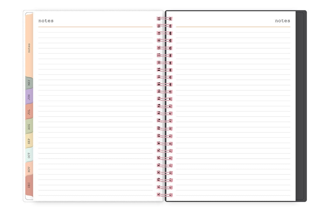 Spiral-bound planner with lined pages and color-coded tabs on a white background