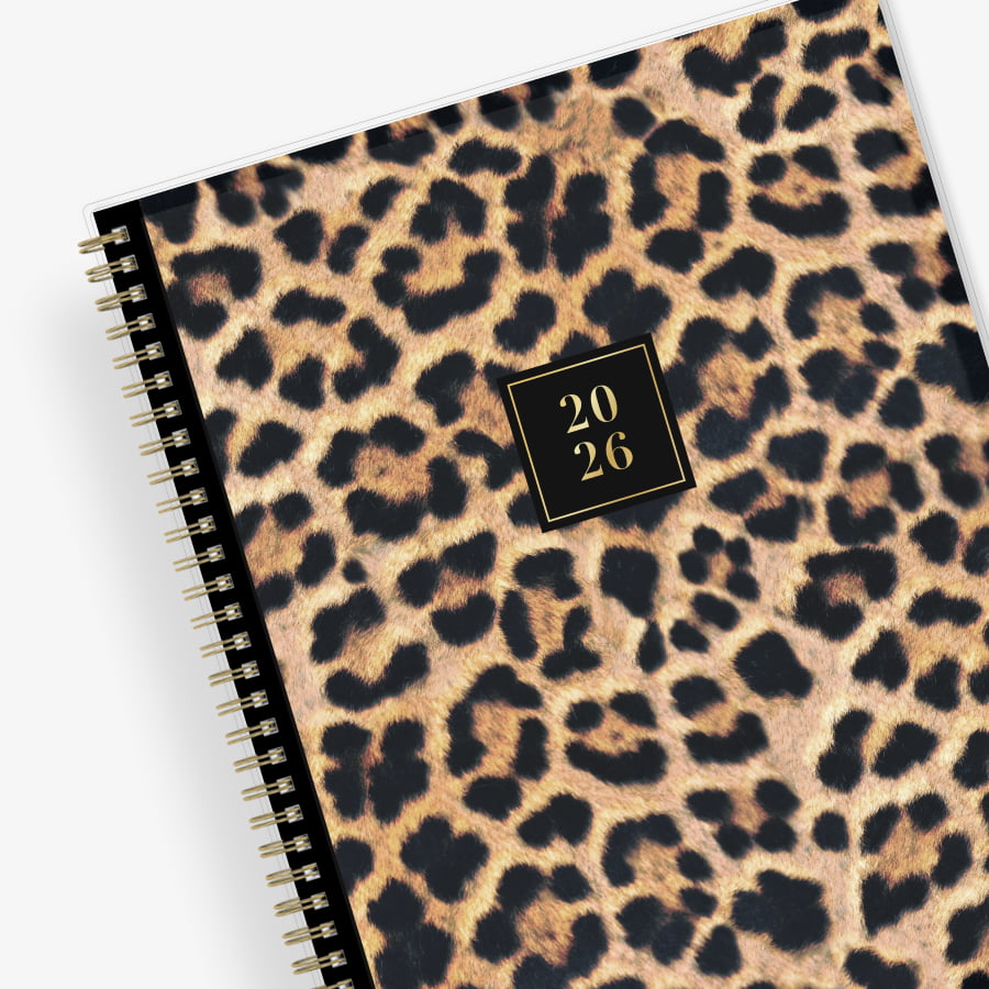 Leopard print planner with a gold spiral binding and &