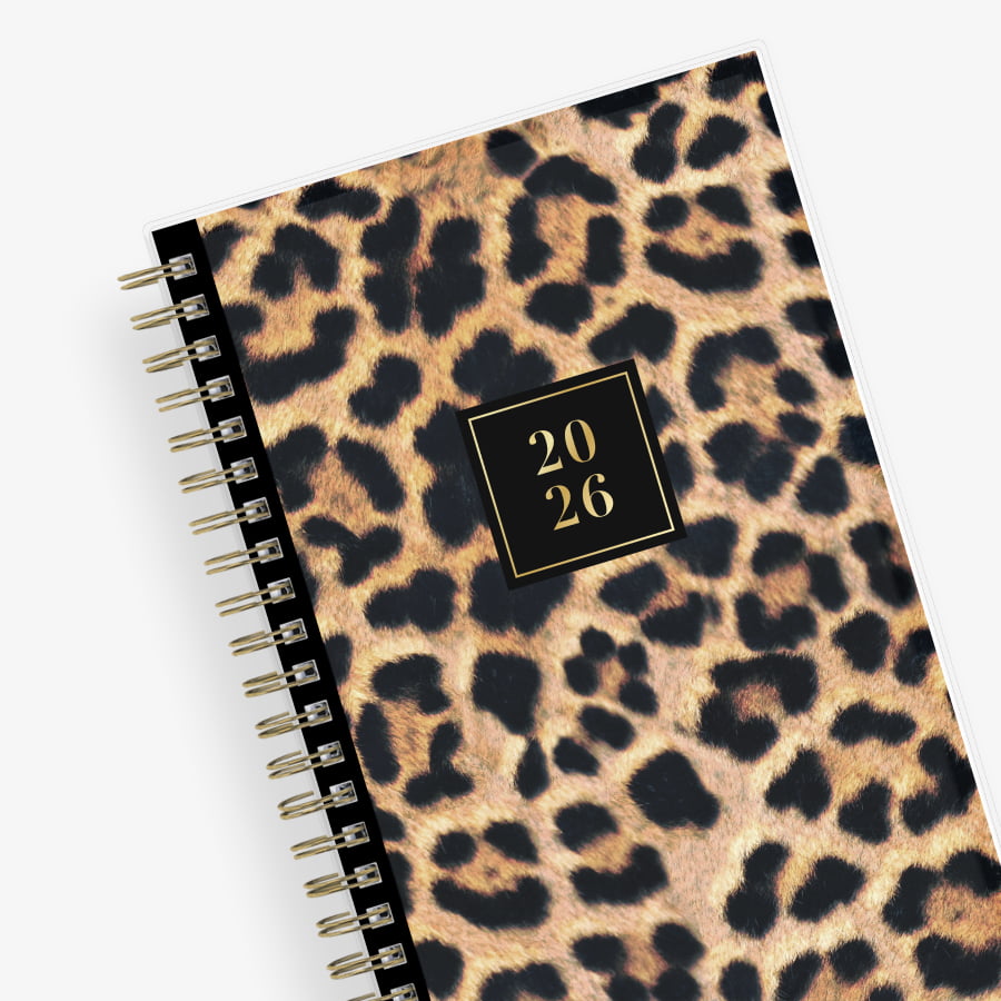Leopard print planner with a gold spiral binding and &