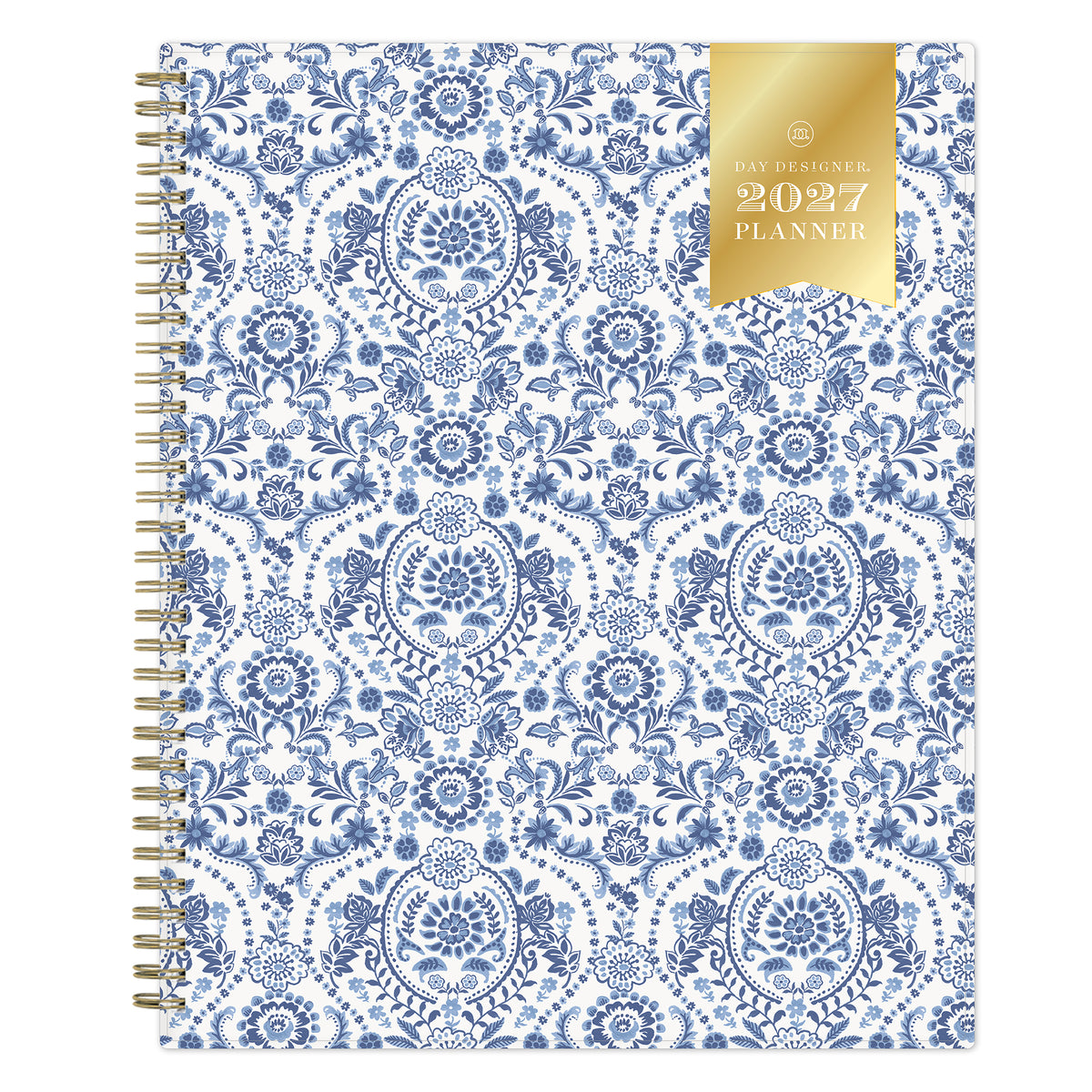 A 2027 weekly monthly planner with a white cover decorated in a blue floral and ornamental pattern, featuring a gold ribbon seal on the top right and a gold spiral binding on the left.