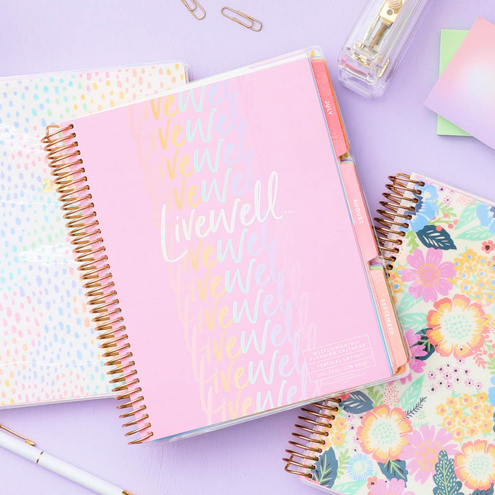 Three LiveWell planners showcasing the sturdy, interior monthly tabs, vibrant covers and coil binding.