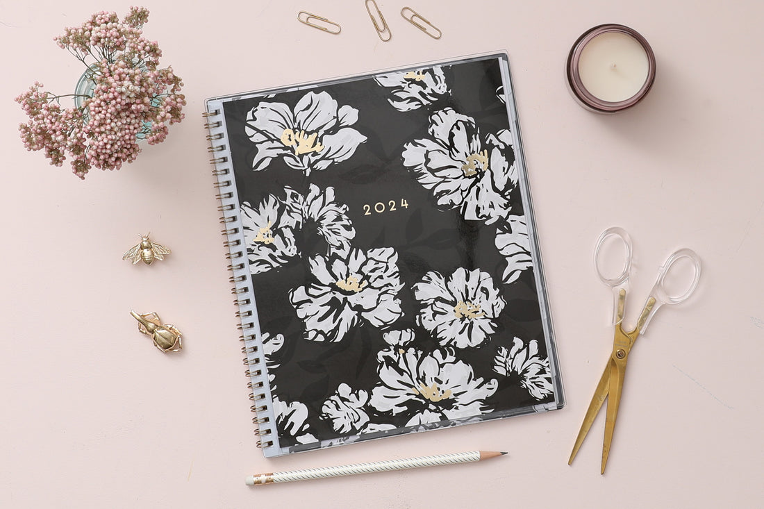 Plan way with this January 2024 - December 2024 monthly planner featuring a floral pattern front cover and gold silver wire-o binding