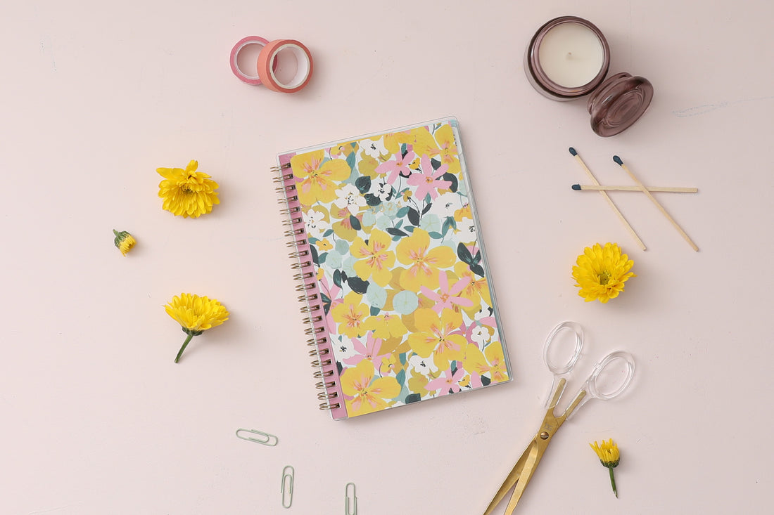 2024 planner weekly monthly featuring gold wire-o and yellow pink flowers