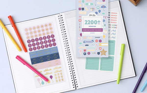 A notebook with vibrant stickers and pens, adding a burst of color and creativity to your organization.