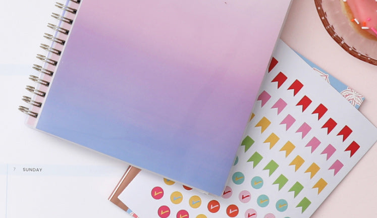 Spiral-bound planner and a sticker sheet