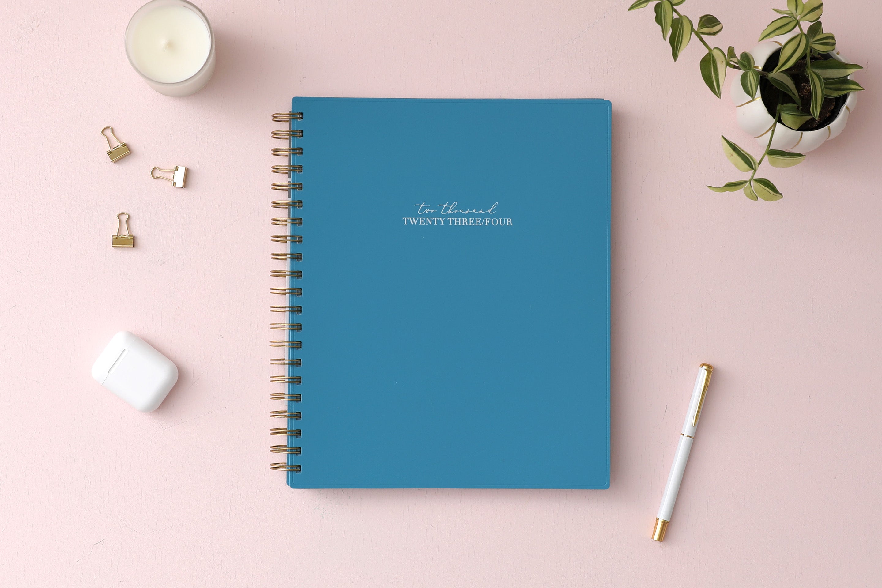 Solid oxford blue front cover with 2023 spelt out, gold twin wire o binding in 8.5x11 planner size