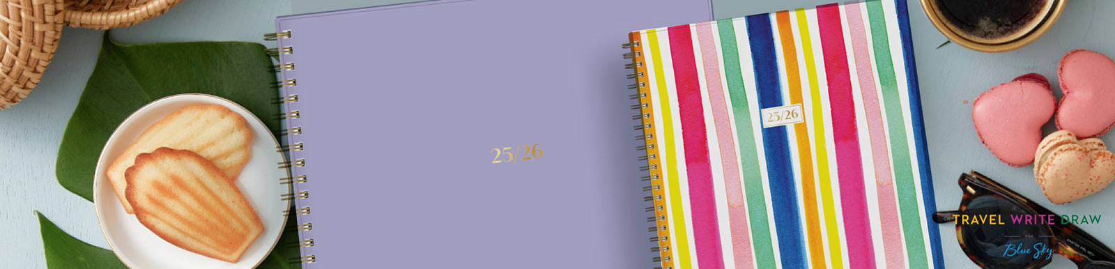 A collection of Travel Write Draw planners and a calendar on an artificial turf background