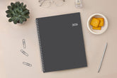 January 2026 - December 2026 weekly monthly planner featuring a charcoal front cover design and silver twin wire-o binding 8.5x11 size