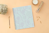 Mint green planner with floral patterns and &