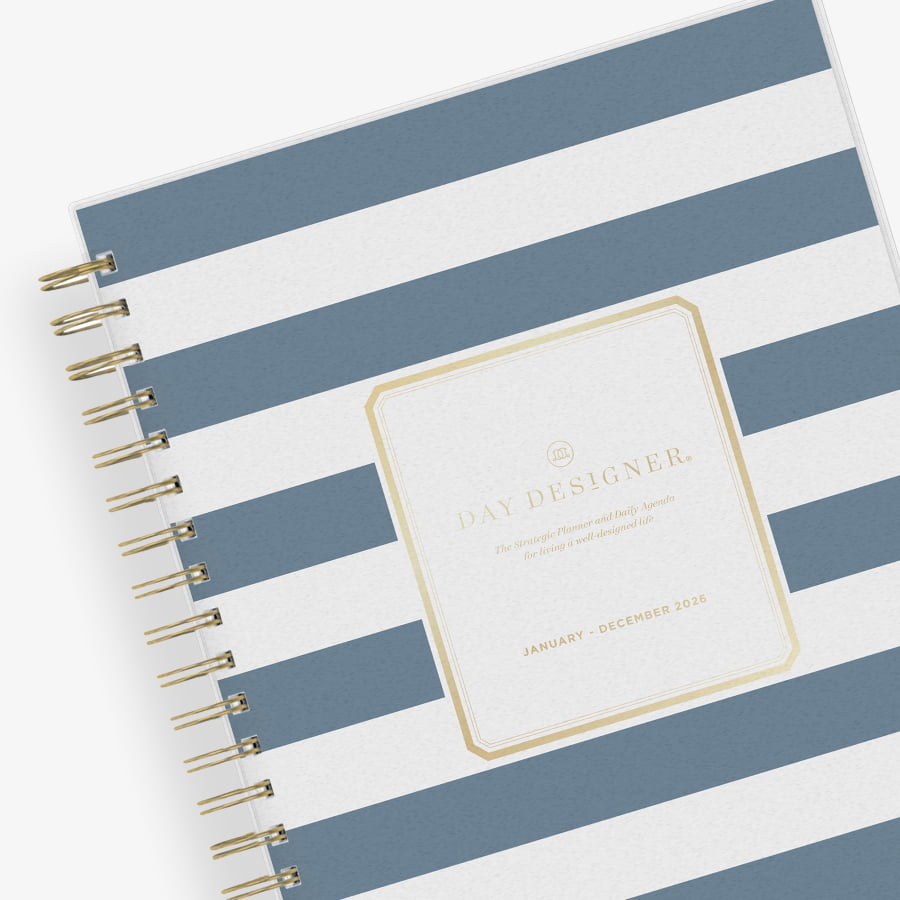 2026 daily monthly from day designer for blue sky featuring a hardcover, navy blue and white stripe design, gold twin wire-o binding in a compact 5x8 planner size.