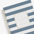 2026 daily monthly from day designer for blue sky featuring a hardcover, navy blue and white stripe design, gold twin wire-o binding in a compact 5x8 planner size.