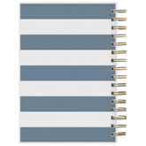 Notebook with blue and white striped cover and gold spiral binding on a white background