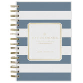 Spiral-bound planner with blue and white striped cover and gold accents