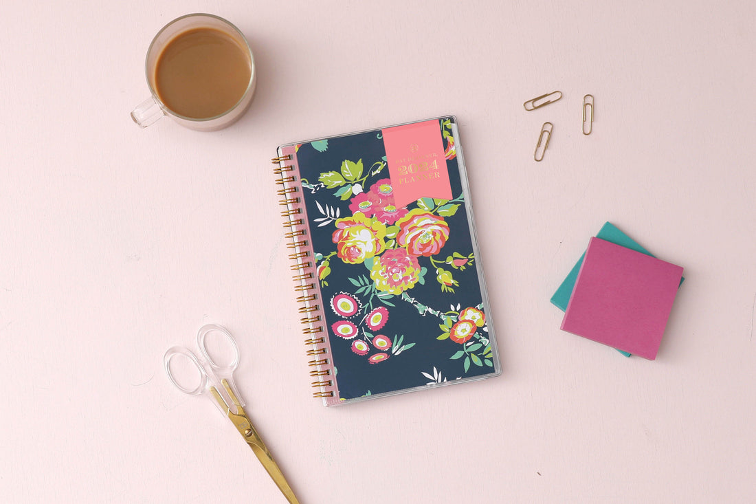 January 2024 - December 2024 weekly monthly planner in 5x8 size from day designer for blue sky with navy background and floral design, and gold twin wire-o binding