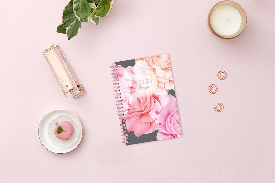 Take planning to the next level with this 2026 weekly monthly planner from Blue Sky featuring a cover with beautiful roses in shades of pink, rose gold twin wire-o binding in 5x8 planner size, and flexible front cover.