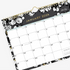 11x8.75 wall calendar for 2023 in baccara dark design featuring gold accents for months and days, black/grey background and white florals