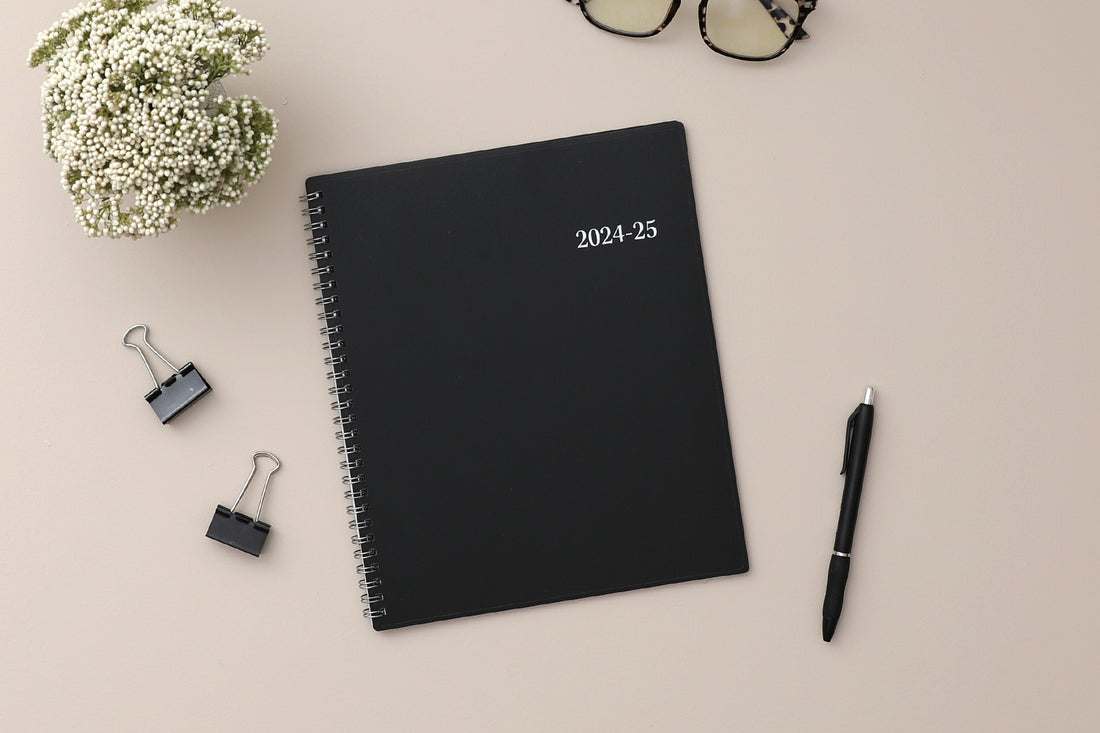 monthly academic planner featuring a solid black cover and silver twin wire-o binding 8x10 size for july 2024 - june 2025