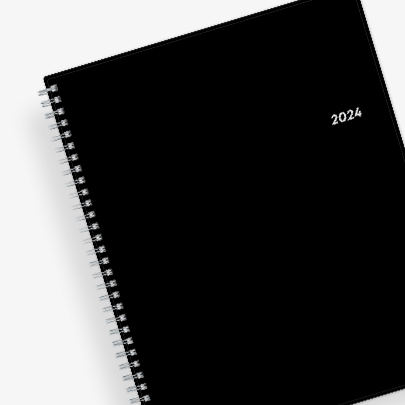 Bilingual January 2024 - December 2024 weekly monthly planner featuring a charcoal front cover design and silver twin wire-o binding 8.5x11 size Calendario De Planificacion.