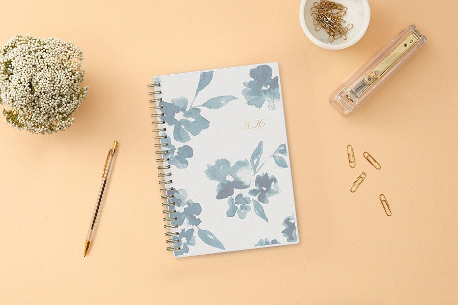 blue sky weekly monthly 2026 planner featuring blue water brushed florals and beige background cover