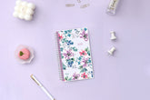 Blue Sky January 2026 - December 2026 weekly monthly planner featuring a floral front cover design with silver wire-o binding