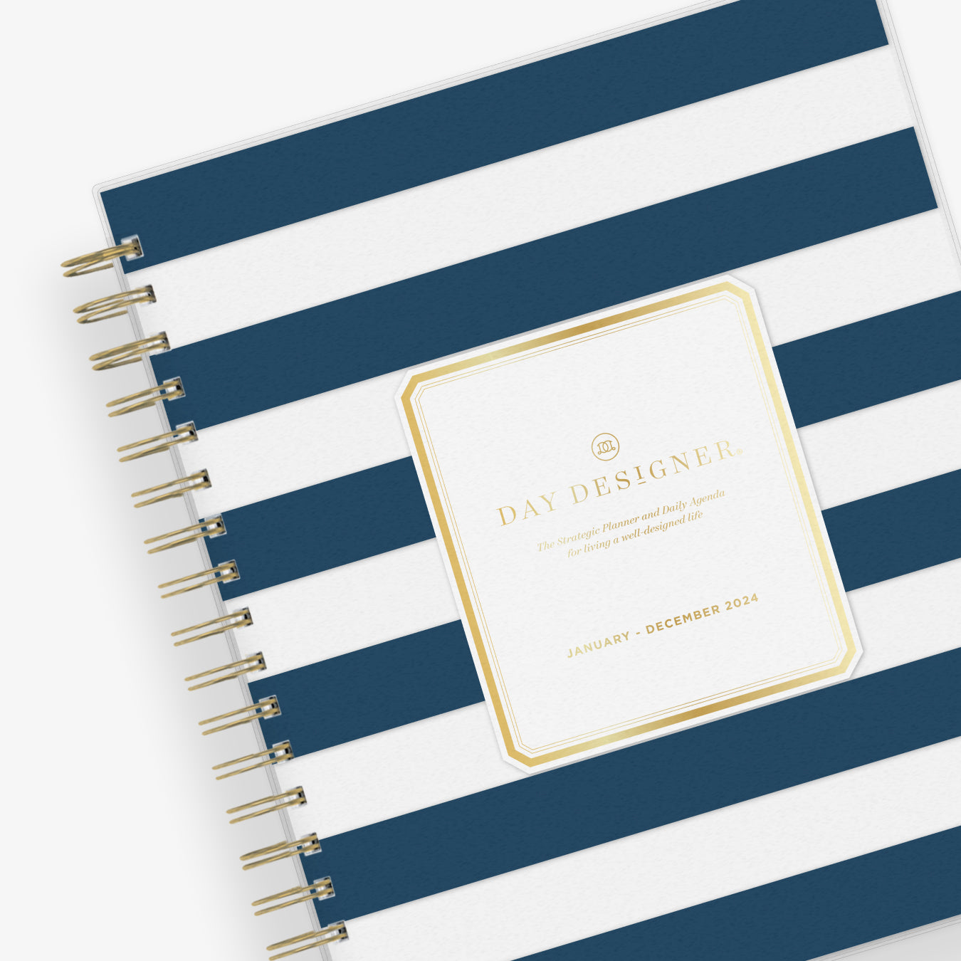 2024 daily monthly from day designer for blue sky featuring a hardcover, navy blue and white stripe design, gold twin wire-o binding in a compact 8x10 planner size.