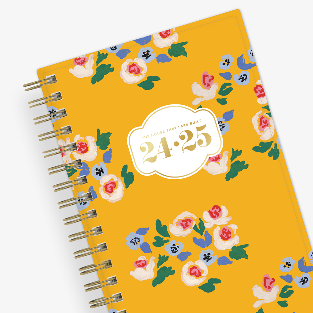 gold yellow background with white and pink fllowers in this pocket sized planner 3.625x6.125 titled The House That Lars Built for year 2024-2025