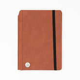 Brown notebook with a black elastic strap on a white background 5.75x8.5