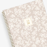 white floral printed front cover on a blush background for this 2025-2026 academic weekly monthly planner