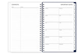 Spiral-bound planner with contact and important dates pages on a white background
