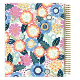 Floral weekly planner with a gold spiral binding on a white background