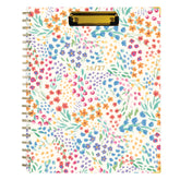 Floral patterned planner with a gold clip on a white background