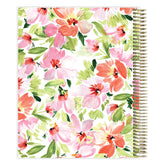 Floral-patterned planner with a spiral binding on a white background