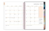 Open planner showing January 2026 with weekly layout and color-coded sections, lined writing space, bullet points, and multi color tabs blank space for dates