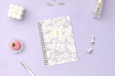 white florals on a purple background for this 2026 5x8 planner