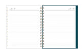 Open spiral-bound notebook with lined pages on a white background