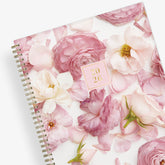 Floral patterned planner with a pink cover on a white background
