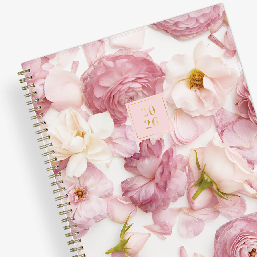 Floral patterned planner with a pink cover on a white background