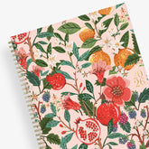 Spiral-bound 2026 planner with floral and fruit design on a pink background