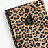 Leopard print planner with a gold spiral binding and &