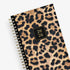 Leopard print planner with a gold spiral binding and &
