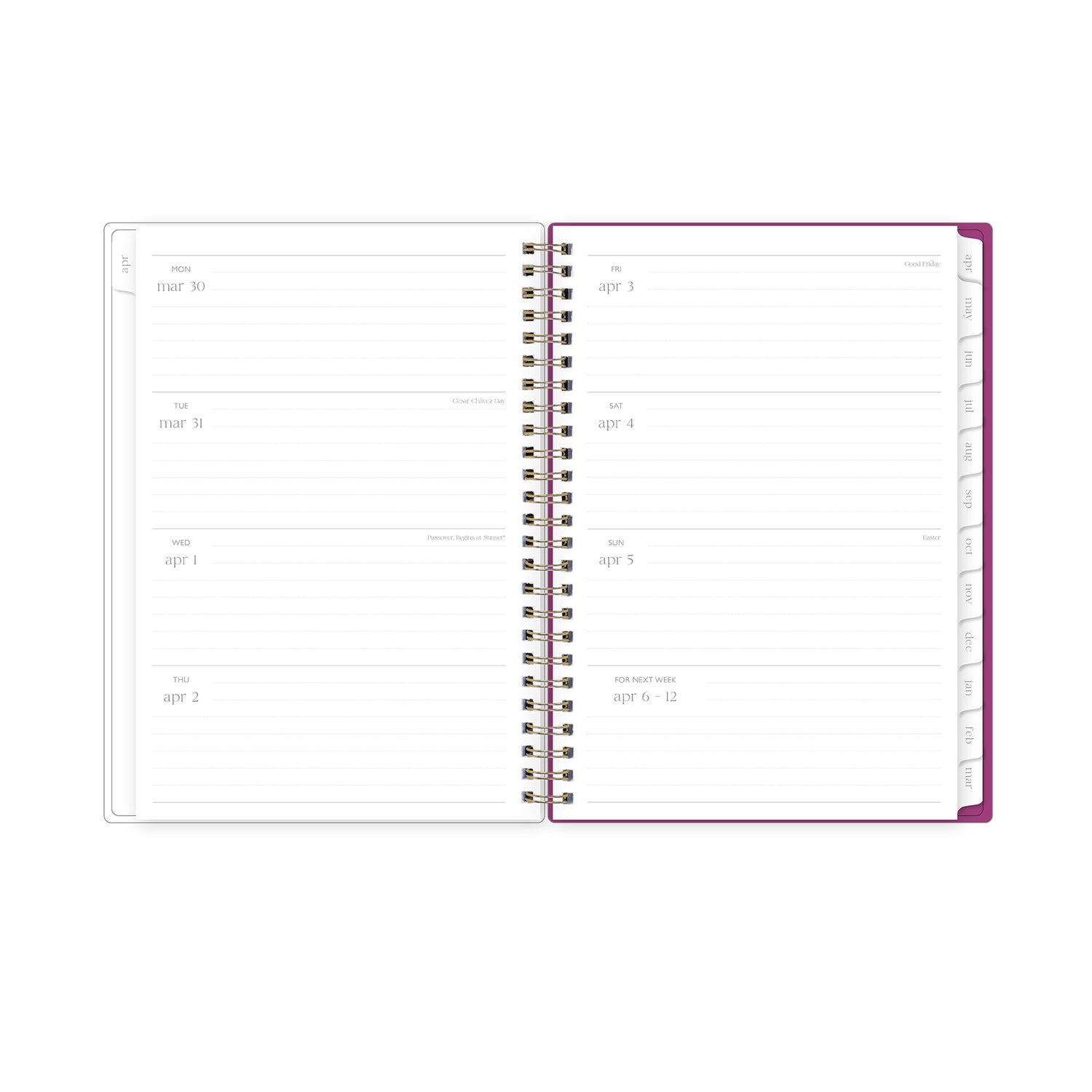 Open spiral-bound planner with handwritten notes on a light surface with pink flowers and stationery items., lined writing space white monthly tabs