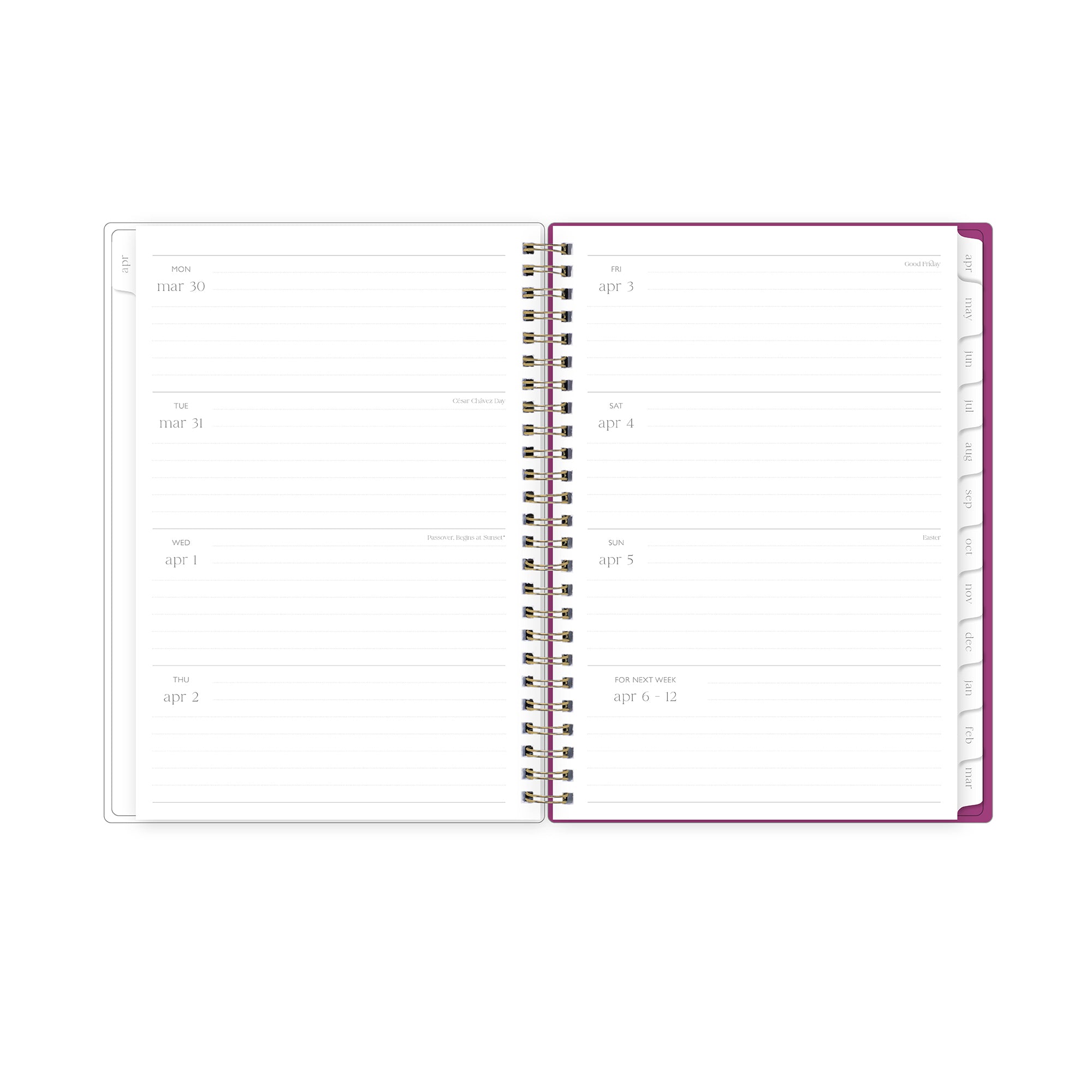 Open spiral-bound planner with handwritten notes on a light surface with pink flowers and stationery items., lined writing space white monthly tabs