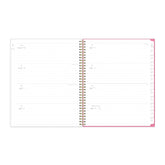 open spread weekly view of this 8.5x11 planner featuring lined writing space and white monthly tabs